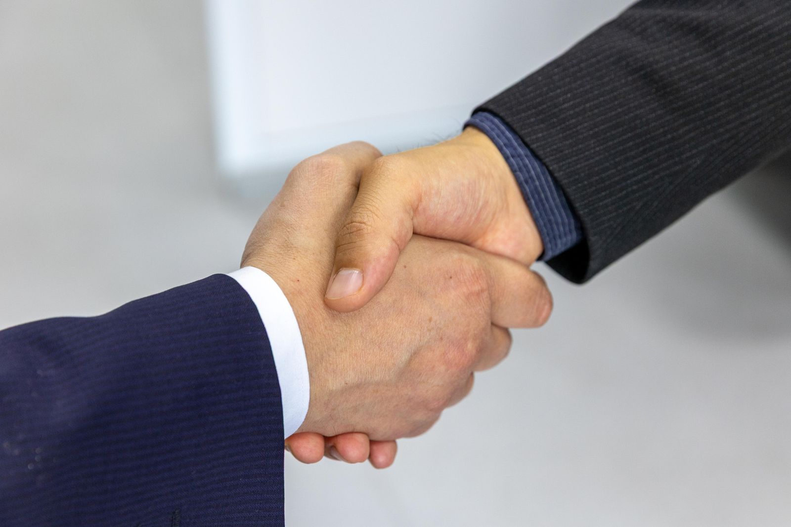 Two business professionals shaking hands in a meeting