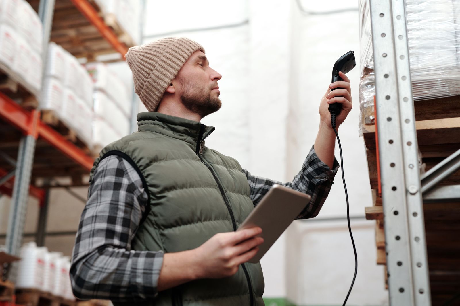 Warehouse worker scanning serialized product with a handheld barcode scanner