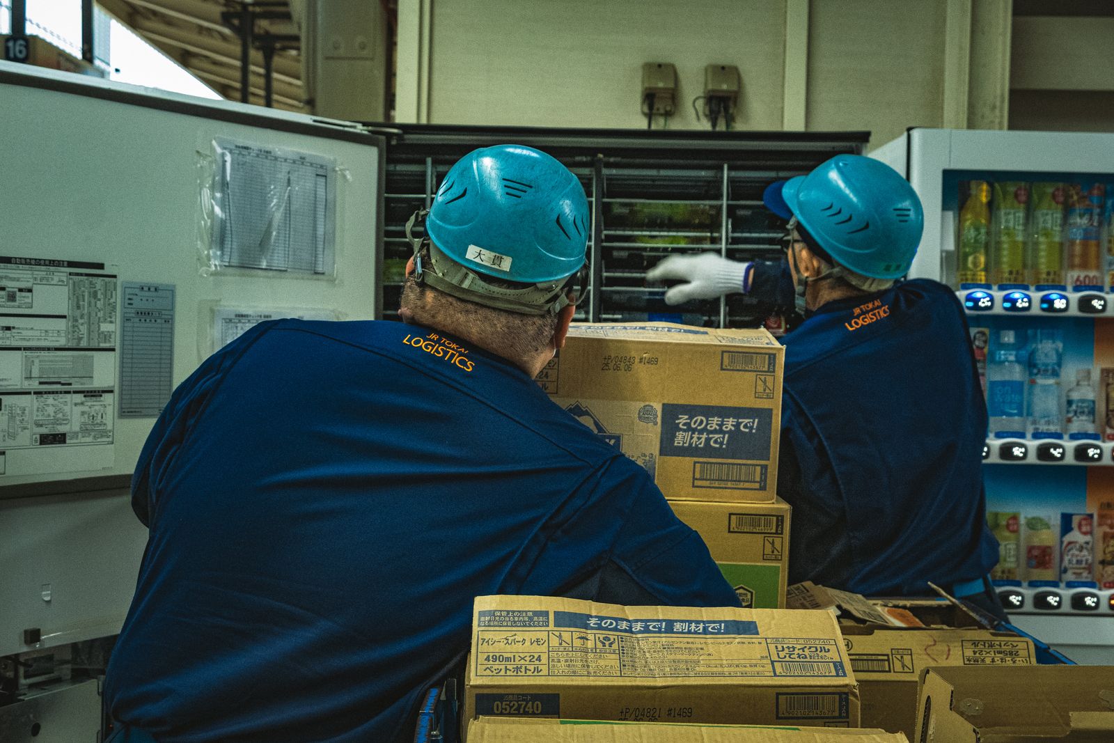 Logistics workers handling boxes in a distribution warehouse